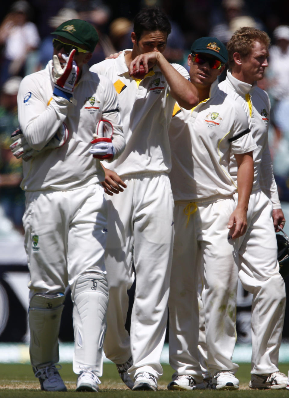 Australia's Mitchell Johnson (2nd L) reacts after taking seven wickets in the inning against England as he walks off the field with teammates Brad Haddin (L) and David Warner (2nd R) during the third day of the second Ashes test cricket match at the Adelaide Oval December 7, 2013.