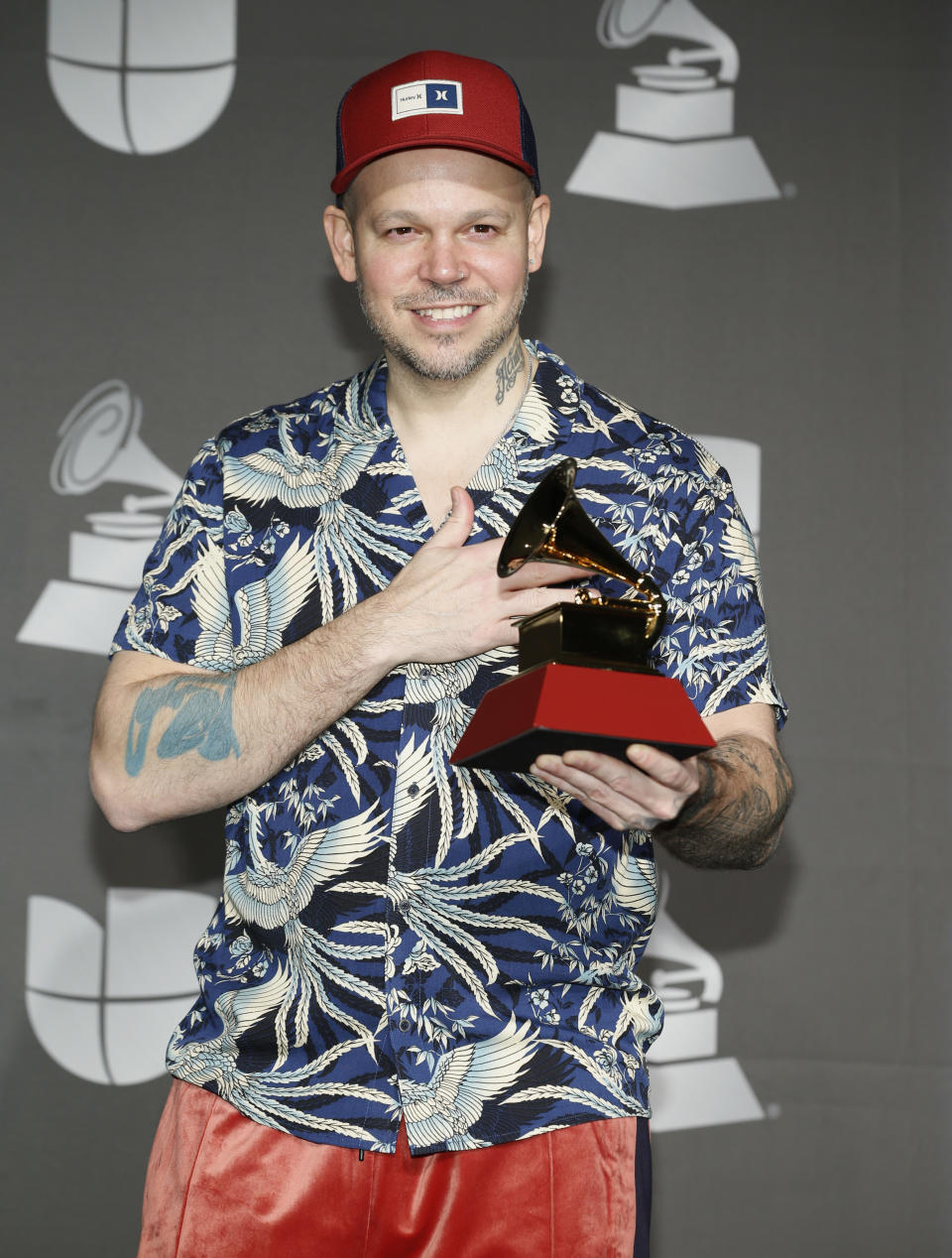 Residente poses in the press room with the award for best short form music video for "Banana Papaya" at the 20th Latin Grammy Awards on Thursday, Nov. 14, 2019, at the MGM Grand Garden Arena in Las Vegas. (Photo by Eric Jamison/Invision/AP)