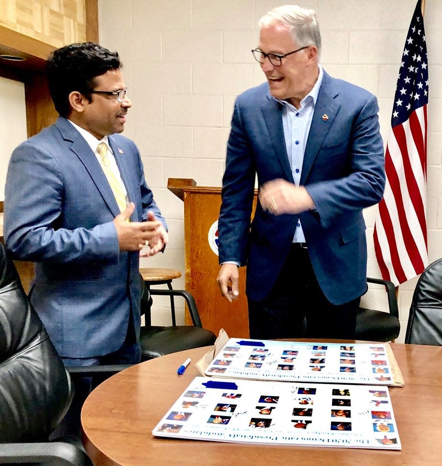 Prakash Kopparapu. left, and Washington Gov. Jay Inslee in 2019.