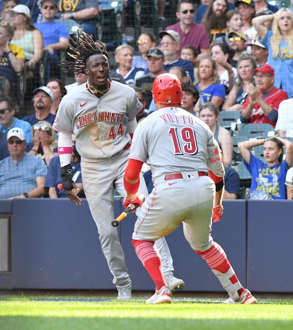 Elly De La Cruz  celebrates with first baseman Joey Votto after scoring a run against the Milwaukee Brewers in the seventh inning Saturday. De La Cruz now has 16 stolen bases.