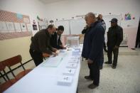 Voters wait to receive ballots at a polling station during the presidential election in Algiers