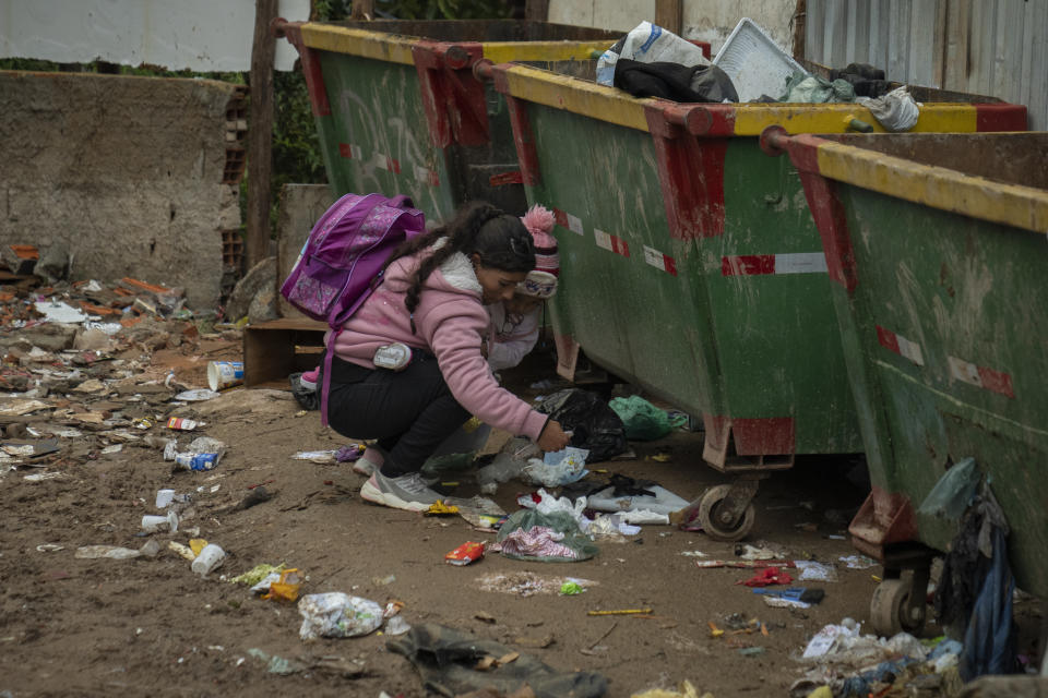 Fernanda holds her daughter Maria Cecilia, 3, while she picks through the trash in Brasiliandia, one of Sao Paulo's poorest neighborhoods, in Brazil, Thursday, Sept. 29, 2022. Although this year the economy started recovering, rampant inflation put even basic foodstuffs out of people's reach and thirty-three million Brazilians experience hunger as they head into the Oct. 2nd general elections. (AP Photo/Victor R. Caivano)