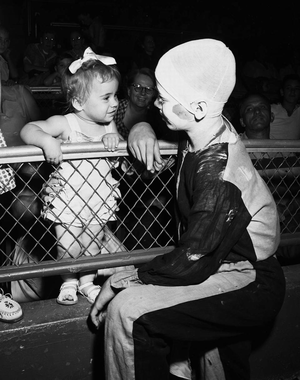 Aug. 14, 1953: 11-month-old Jamelyn Eldredge, daughter of Mr. and Mrs. J. E. Eldredge, can’t believe her eyes as she sees her first circus clown. The clown is Glenn Ray Walker, 12.