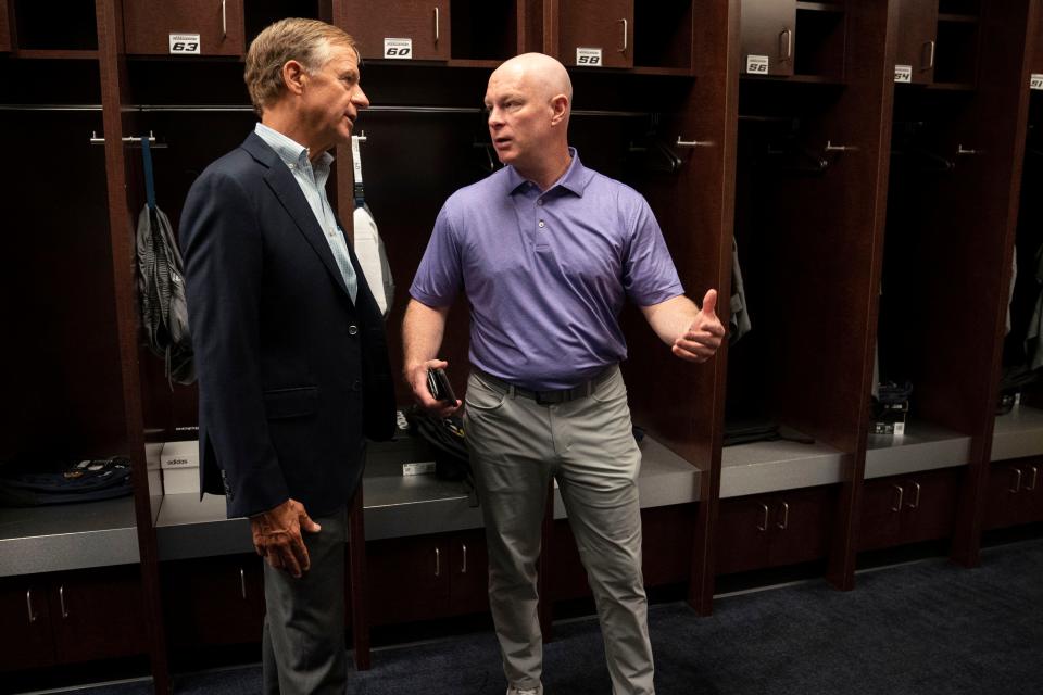 Former Tennessee Governor Bill Haslam visits with Nashville Predators head coach John Hynes in the team's locker room at Bridgestone Arena Thursday, June 23, 2022, in Nashville, Tenn.  Haslam is in negotiations to purchase controlling interest of the NHL hockey team over a three year period.