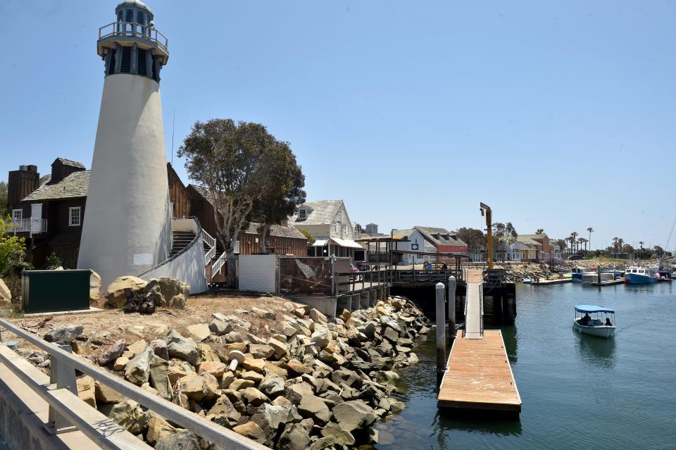 A boat cruises past the dock at Fisherman's Wharf in Oxnard in 2021. The latest plans to overhaul the area include a maritime theme.