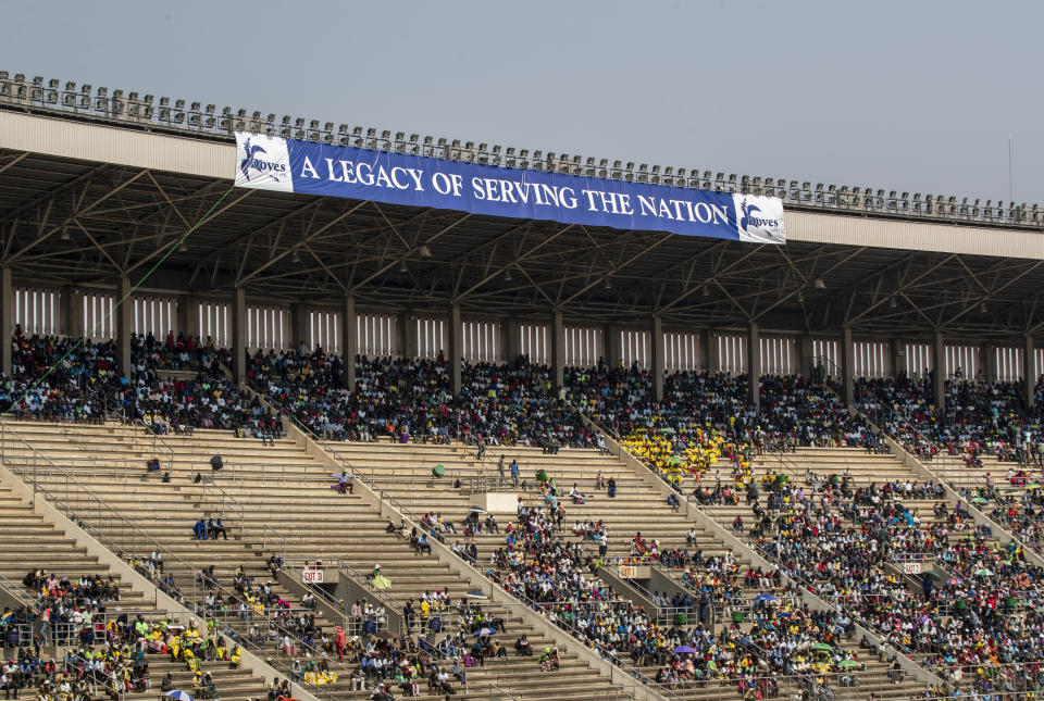 Members of the public sit in the stands during the state funeral for former president Robert Mugabe at the National Sports Stadium in the capital Harare, Zimbabwe Saturday, Sept. 14, 2019. African heads of state and envoys gathered to attend a state funeral for Zimbabwe's founding president, Robert Mugabe, whose burial has been delayed for at least a month until a special mausoleum can be built for his remains. (AP Photo/Ben Curtis)