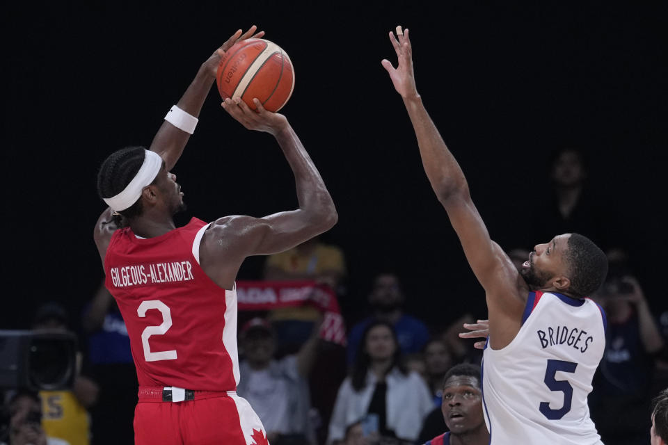 Canada guard Shai Gilgeous-Alexander (2) shoots against U.S. forward Mikal Bridges (5) during the Basketball World Cup bronze medal game between the United States and Canada in Manila, Philippines, Sunday, Sept. 10, 2023. (AP Photo/Michael Conroy)
