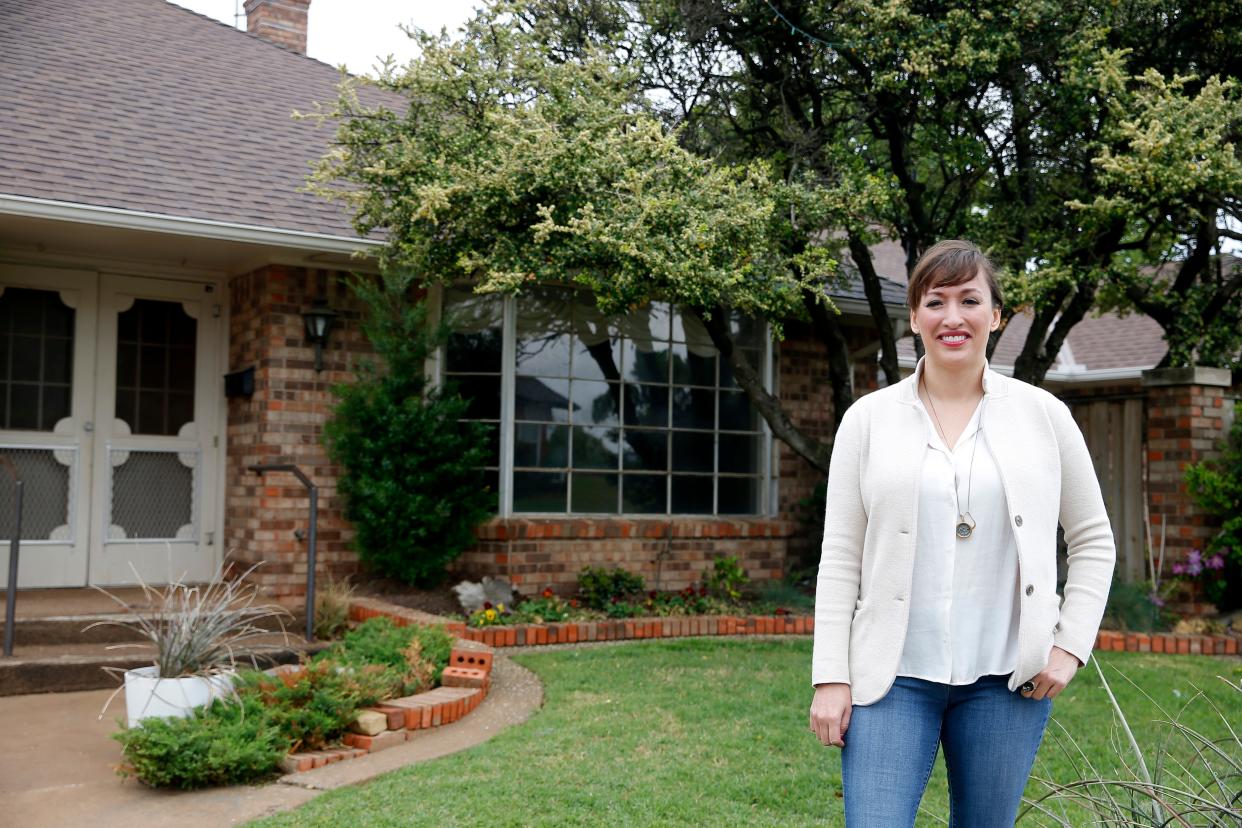 Jennifer Arsenault, managing broker of Flotilla Real Estate Partners, stands in front of a duplex home she sold on N Miller Avenue.