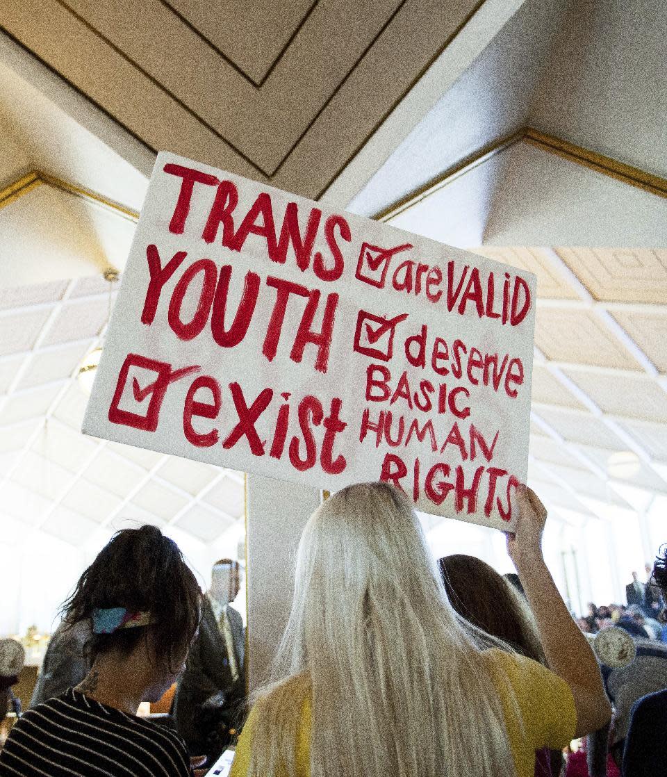 Hunter Schafer, of Raleigh, holds a sign in favor of repealing North Carolina HB2 during a special session of the North Carolina General Assembly in Raleigh, N.C., Wednesday, Dec. 21, 2016. North Carolina's legislature is reconvening to see if enough lawmakers are willing to repeal the 9-month-old law that limited LGBT rights, including which bathrooms transgender people can use in public schools and government buildings.(AP Photo/Ben McKeown)