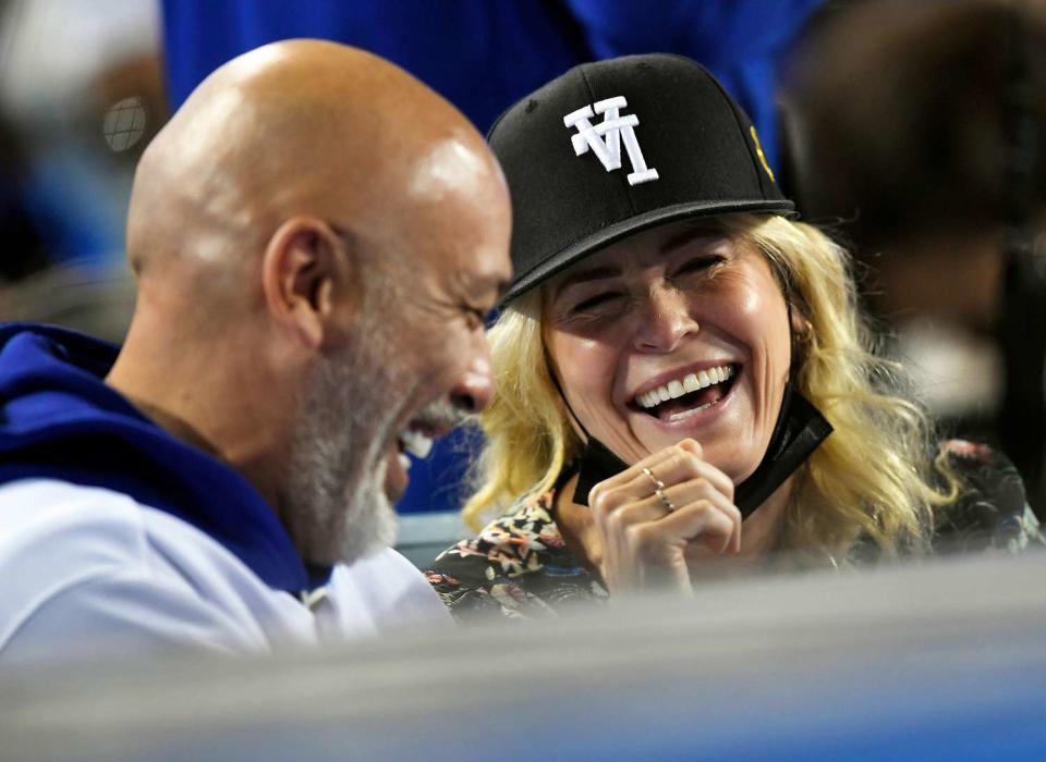 Chelsea Handler and Jo Koy attend the game between the San Diego Padres and the Los Angeles Dodgers at Dodger Stadium on September 28, 2021 in Los Angeles, California