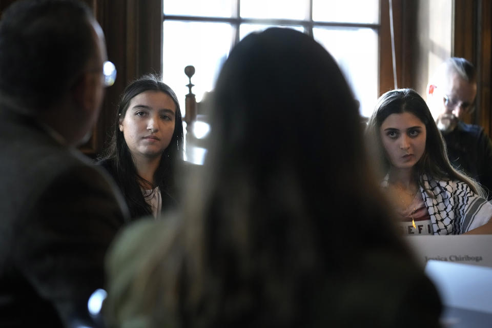 Dartmouth College students Jessica Chiriboga, of Glendora, Calif., behind left, and Yasmine Abouali, of Abu Dhabi, behind right, speak with U.S. Education Secretary Miguel Cardona, foreground left, and Dartmouth College President Sian Leah Beilock, foreground center, while participating in a roundtable discussion, Wednesday, Jan. 10, 2024, on the school's campus, in Hanover, N.H. Fallout from the Israel-Hamas war has roiled campuses across the U.S. and reignited a debate over free speech. (AP Photo/Steven Senne)