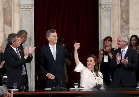 Argentina's President Mauricio Macri (center L) and vice-president Gabriella Michett (center R) gestures after being sworn-in to office at the Argentine Congress in Buenos Aires, Argentina, December 10, 2015. REUTERS/Andres Stapff