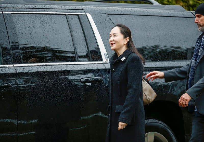 Huawei Chief Financial Officer Meng Wanzhou greets the media as she leaves her home to attend her extradition hearing in Vancouver