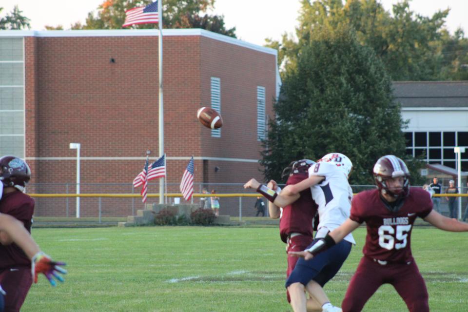 Britton Deerfield's Leland Smith hits Morenci quarterback Shamus Alcock as he attempts to pass during Friday's game in Morenci.