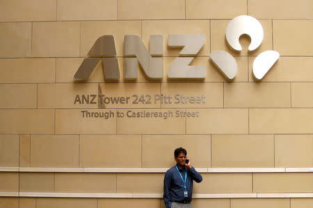 A man talks on his phone in front of an ANZ Banking corporation tower in central Sydney, Australia February 20, 2018. REUTERS/Daniel Munoz