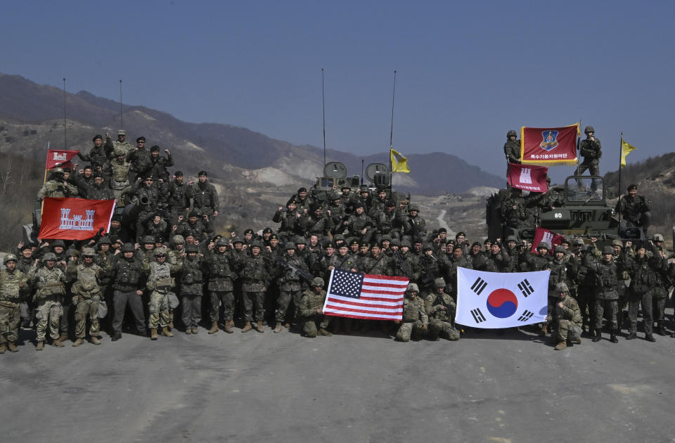 South Korean and U.S. soldiers pose for photos after their joint live fire exercise at a military training field in Pocheon, South Korea Thursday, March 14, 2024 as part of the annual Freedom Shield joint military exercise between South Korea and the United States. (Jung Yeon-je/Pool Photo via AP)