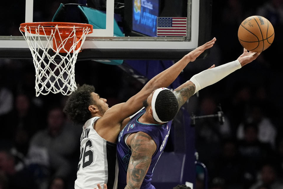 Charlotte Hornets forward Miles Bridges shoots over San Antonio Spurs forward Dominick Barlow during the first half of an NBA basketball game on Friday, Jan. 19, 2024, in Charlotte, N.C. (AP Photo/Chris Carlson)