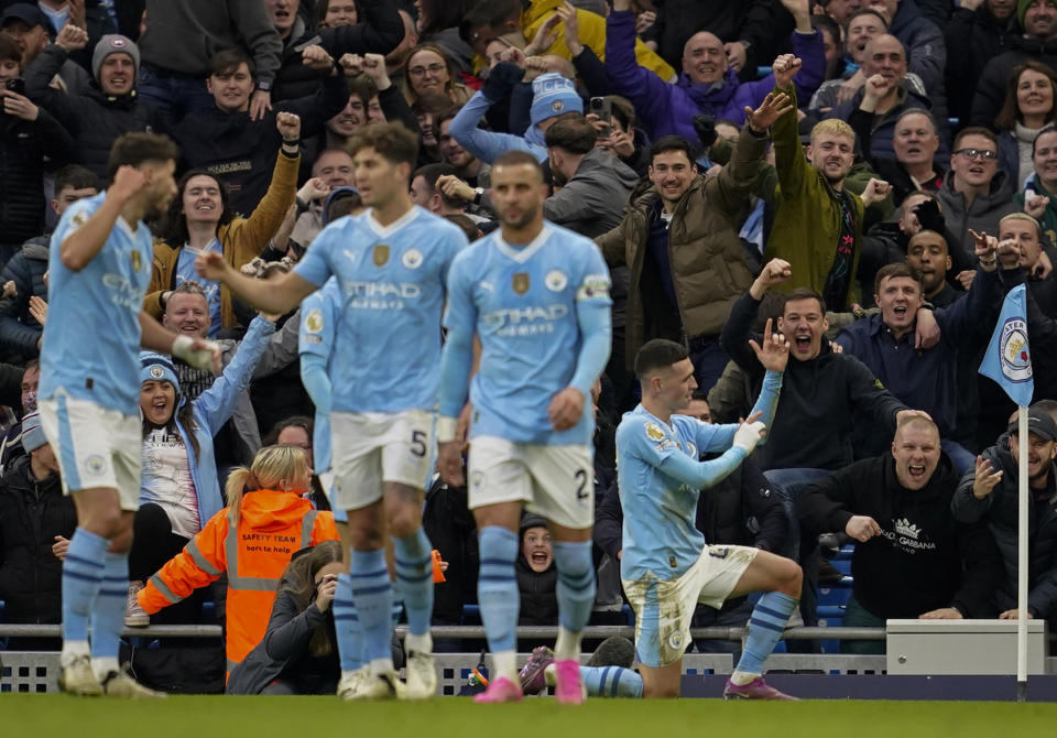 Manchester City's Phil Foden, right, celebrates after scoring his side's second goal during an English Premier League soccer match between Manchester City and Manchester United at the Etihad Stadium in Manchester, England, Sunday, March 3, 2024. (AP Photo/Dave Thompson)