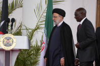 Iran's President Ebrahim Raisi, center, and Kenya's President William Ruto, right, arrive to give a joint press conference after meeting at State House in Nairobi, Kenya Wednesday, July 12, 2023. Iran's president has begun a rare visit to Africa as the country, which is under heavy U.S. economic sanctions, seeks to deepen partnerships around the world. (AP Photo/Khalil Senosi)