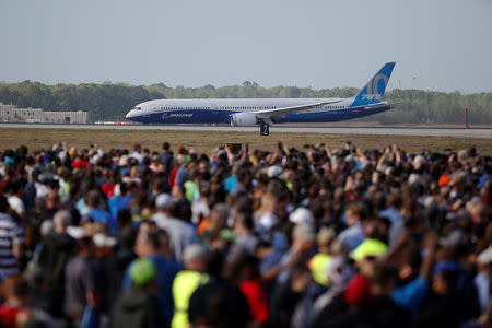 Employees and guest watch during the first flight ceremony of the new Boeing 787-10 Dreamliner at the Charleston International Airport in North Charleston, South Carolina, United States March 31, 2017. REUTERS/Randall Hill