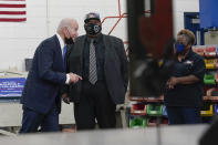 President Joe Biden talks with Will Howard, President of Amalgamated Transit Union (ATU) Local 1287, and LaVale Smith during a tour of the bus repair garage at the Kansas City Area Transit Authority, Wednesday, Dec. 8, 2021, in Kansas City, Mo. (AP Photo/Alex Brandon)