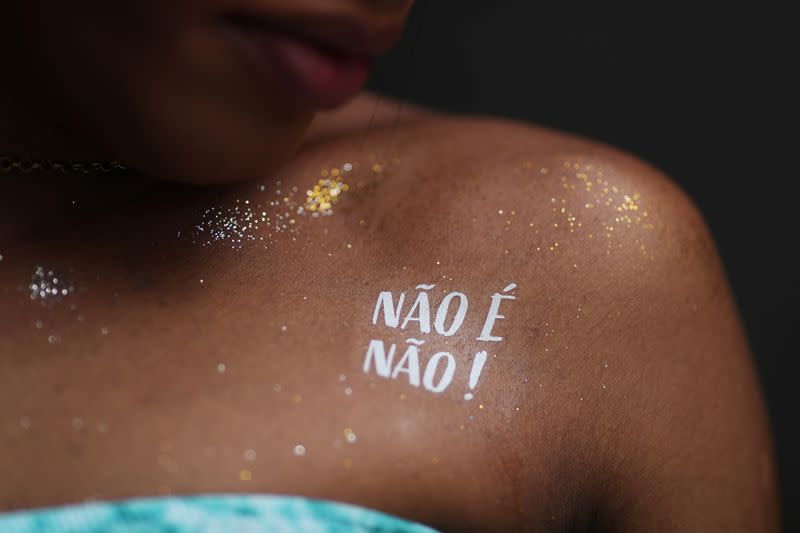 A temporary tattoo that reads “No means No” is seen on Luna Souza, a “Carnival Angel” during a carnival block party in Sao Paulo