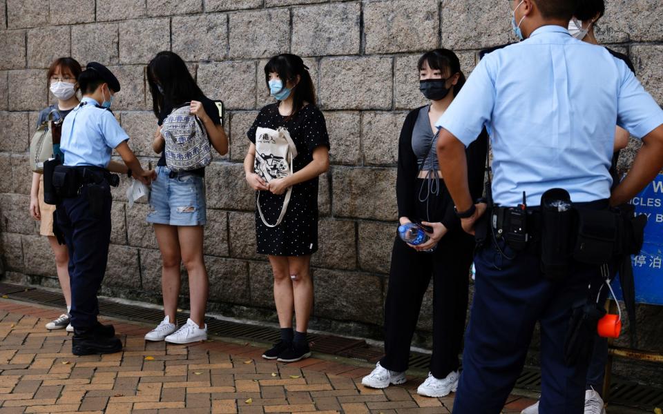 Police stop and search young people outside the High Court. - TYRONE SIU /REUTERS 