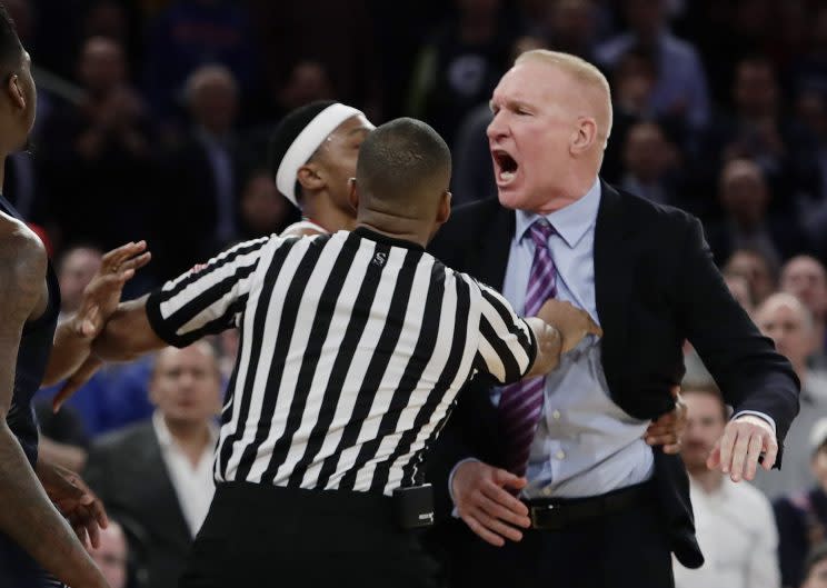 St. John’s head coach Chris Mullin is held back by referees during a Big East tournament game against Georgetown on Wednesday March 8, 2017. (Associated Press)