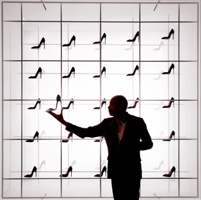 <p>Christian Louboutin poses in front of an installation of the “Christian Louboutin: Exhibition[niste]” show at the Palais de la Porte Dorée in Paris. Photo: Jennifer Livingston</p>