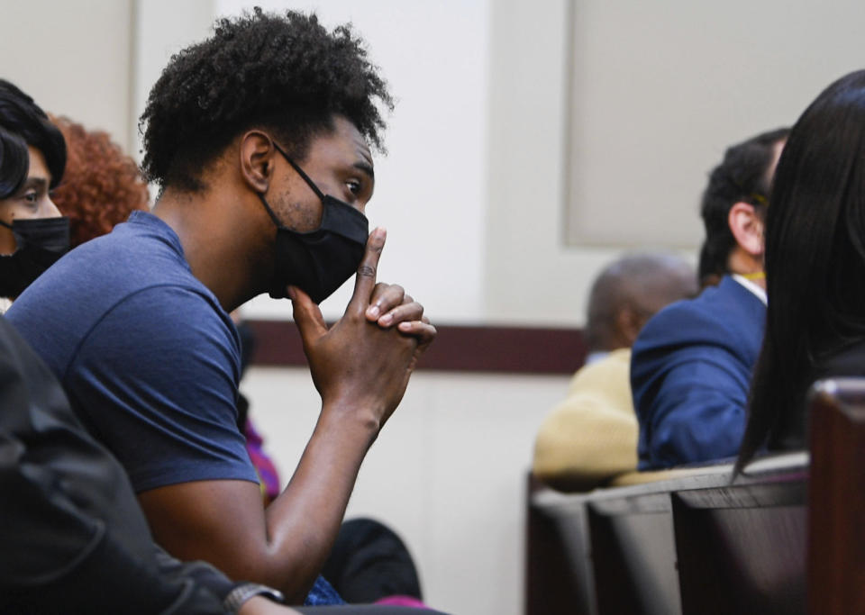 Di'Angelo Groves, a brother of Waffle House shooting victim DeEbony Groves, sits in the gallery listening during Travis Reinking's murder trial, Wednesday, Feb. 2, 2022, in Nashville, Tenn. Reinking is charged with four counts of first degree murder, along with other attempted murder and weapons charges for a shooting in 2018 at a Nashville Waffle House. (Stephanie Amador/The Tennessean via AP, Pool)