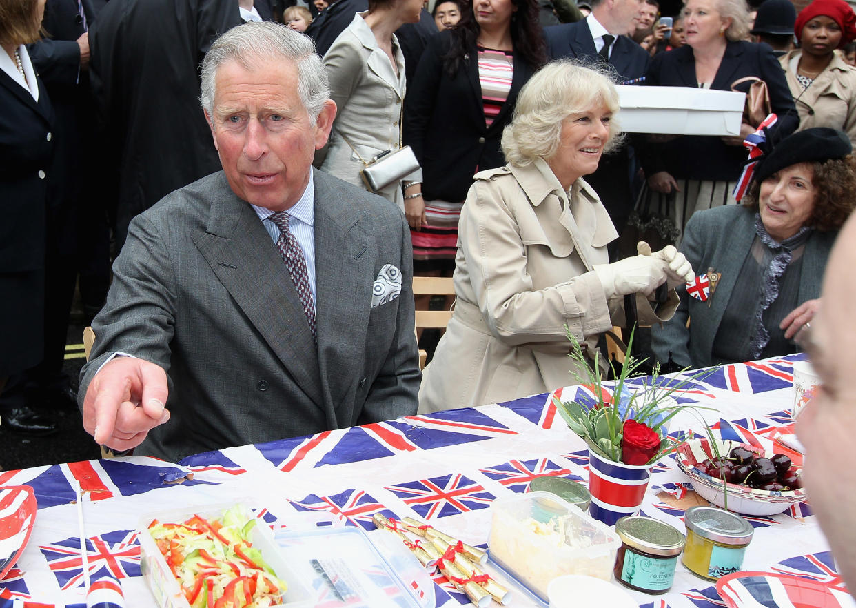 LONDON, ENGLAND - JUNE 03:  Prince Charles, Prince of Wales and Camilla, Duchess of Cornwall attend the 'Big Jubilee Lunch' in Piccadilly ahead of the Diamond Jubilee River Pageant on June 3, 2012 in London, England. For only the second time in its history the UK celebrates the Diamond Jubilee of a monarch. Her Majesty Queen Elizabeth II celebrates the 60th anniversary of her ascension to the throne. Thousands of well-wishers from around the world have flocked to London to witness the spectacle of the weekend's celebrations. The Queen along with all members of the royal family will participate in a River Pageant with a flotilla of a 1,000 boats accompanying them down The Thames.  (Photo by Chris Jackson - WPA Pool/Getty Images)
