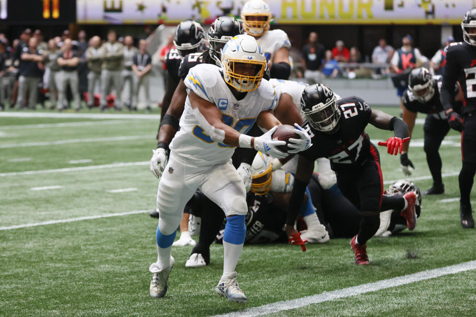 CORRECTS DATE TO SUNDAY, NOV. 6 INSTEAD OF TUESDAY, DEC. 6 - Los Angeles Chargers running back Austin Ekeler scores on a 2-yard touchdown run during the first half of an NFL football game against the Atlanta Falcons, Sunday, Nov. 6, 2022, in Atlanta. (AP Photo/Butch Dill)