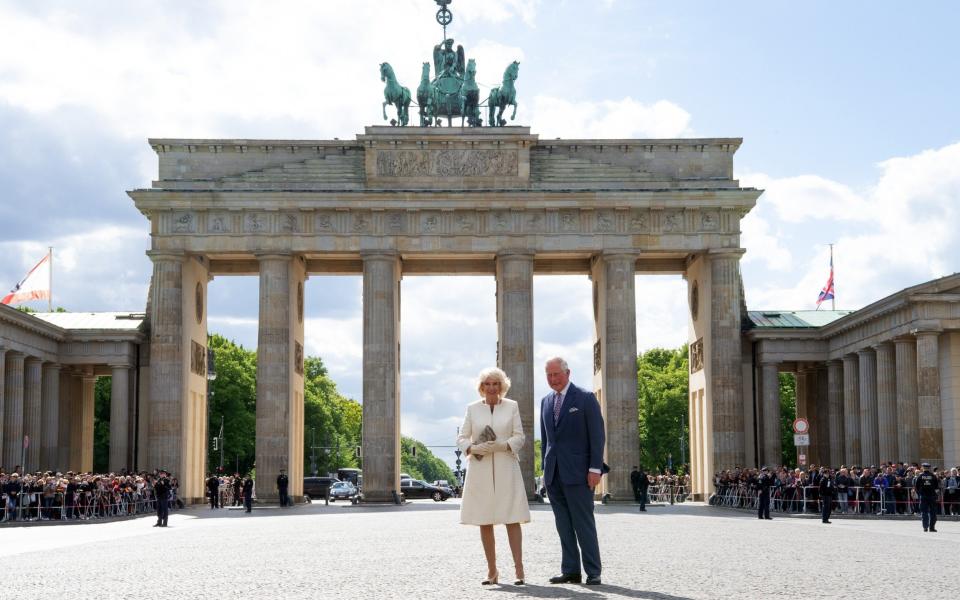 The then Prince Charles and his wife Camilla pose in front of the Brandenburg Gate during their visit to Berlin in May 2019 - Soeren Stache/DPA/AFP via Getty Images