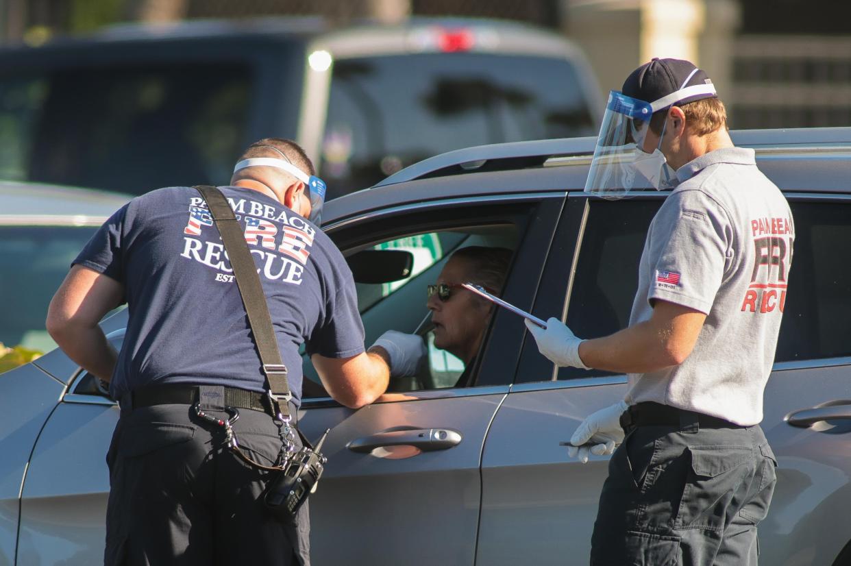 Palm Beach Fire-Rescue workers administer a COVID-19 rapid antigen test to a resident Jan. 6 at Phipps Ocean Park.