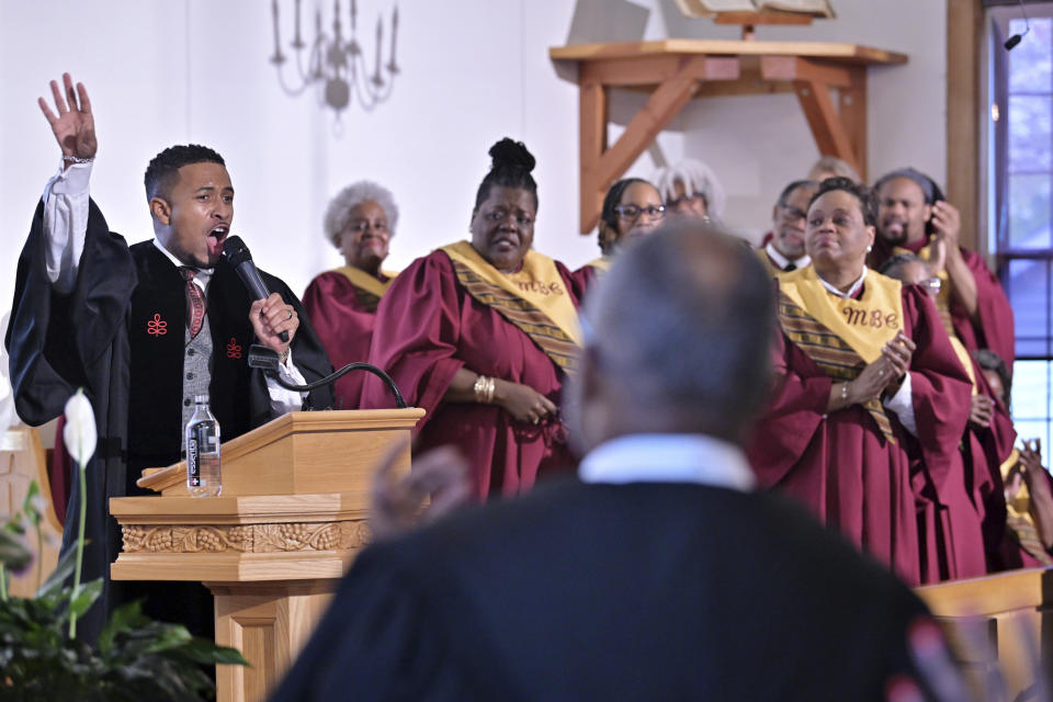 The Rev. Brandon Thomas Crowley, left, speaks during Sunday service at Myrtle Baptist Church in Newton, Mass., on Sunday, May 5, 2024. Crowley felt he was called to be a Christian pastor — a preacher of the social justice gospel. (AP Photo/Josh Reynolds)