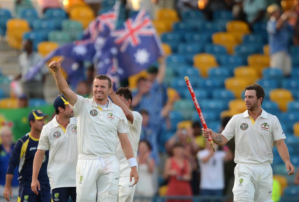 Australian cricketers celebrate their victory at the end of the final day of the first-of-three Test matches between Australia and West Indies at the Kensington Oval stadium in Bridgetown on April 11, 2012. Australia defeated West Indies by 3 wickets. AFP PHOTO/Jewel Samad (Photo credit should read JEWEL SAMAD/AFP/Getty Images)