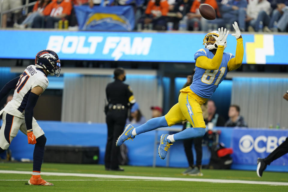 Los Angeles Chargers wide receiver Mike Williams (81) catches a touchdown in front of Denver Broncos free safety Justin Simmons during the second half of an NFL football game Sunday, Jan. 2, 2022, in Inglewood, Calif. (AP Photo/Ashley Landis)