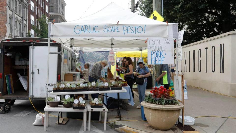 Blue Moon Farm’s booth sells to customers on Saturday, June 17, 2023 at the Fifth Third Pavilion in Lexington, Ky. They offer several fresh products but be sure to try their garlic offerings.