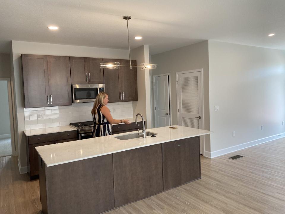 Sarah Tuttle, Northside Place resident manager, showing the kitchen at a built-to-rent home at Northside Place.