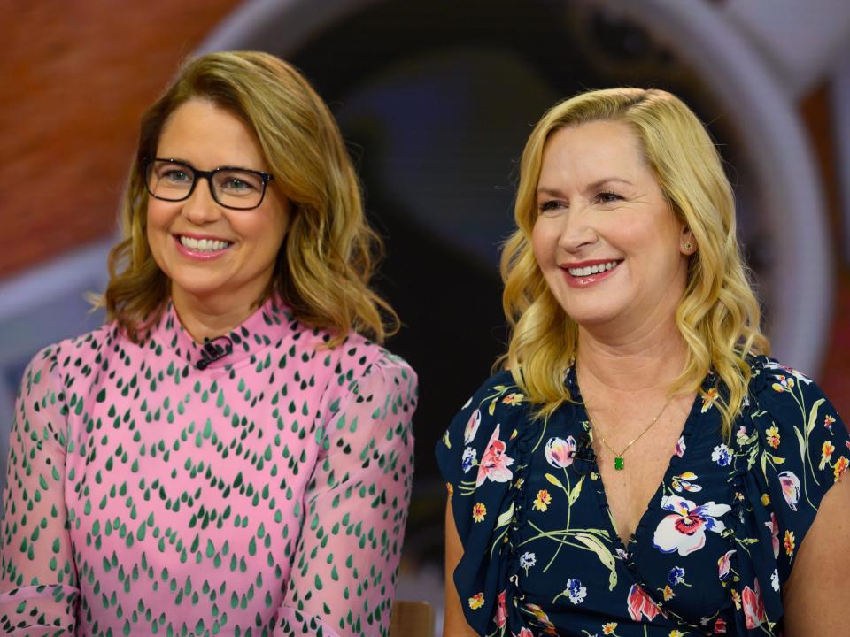 Jenna smiling in glasses and a pink dress and Angela smiling in a black floral dress.