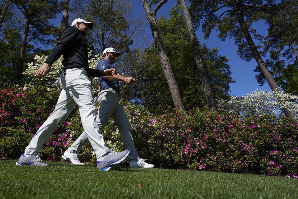 Rory McIlroy, of Northern Ireland, and Dustin Johnson walk along the sixth hole during a practice round for the Masters golf tournament on Monday, April 5, 2021, in Augusta, Ga. (AP Photo/David J. Phillip)