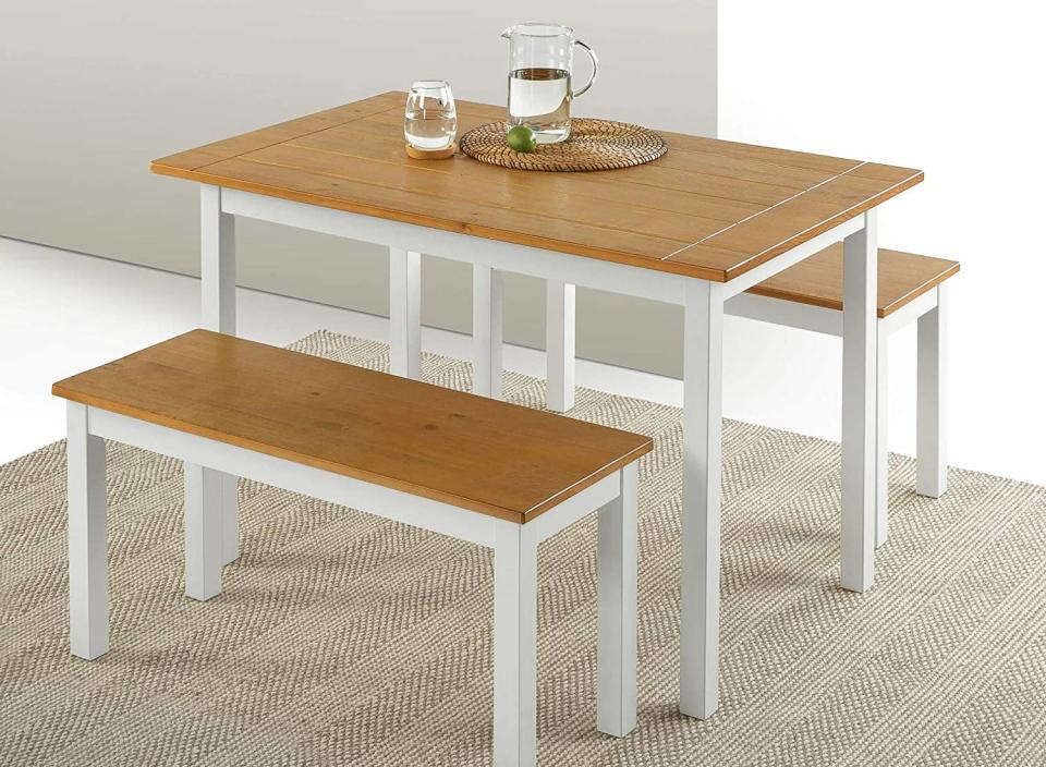 This farmhouse-inspired dining set comes with two adorable stools that can be easily moved around. (Source: Amazon)