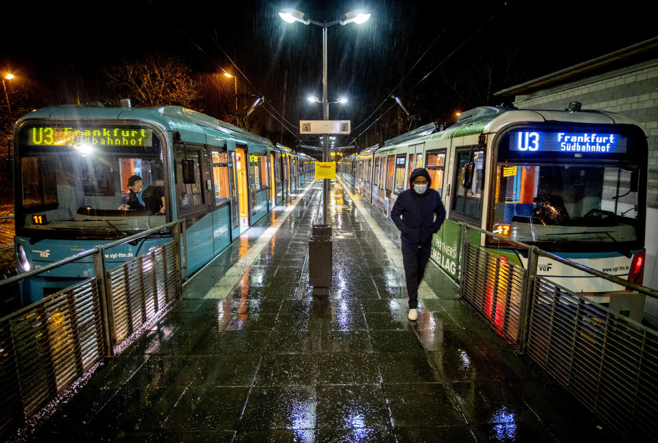 A man wearing a face mask has left a train at a subway station in Oberursel near Frankfurt, Germany, on early Monday, March 15, 2021. Numbers of Corona infections in Germany are rising again. (AP Photo/Michael Probst)