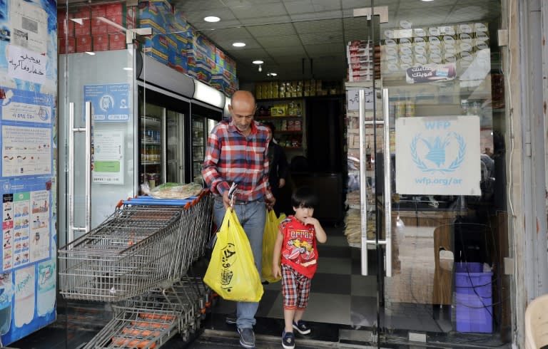 A Syrian refugee shops at a store that accepts payment with debit cards provided by the United Nations' World Food Programme, in Beirut on June 14, 2017