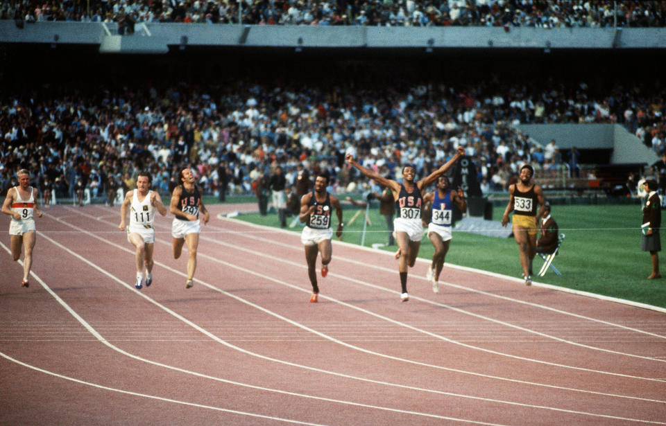 American athlete Tommie Smith (third from right), wearing black socks, jubilates after crossing the finish line of the men's 200m final ahead of Australian Peter Norman and compatriot John Carlos during the Mexico Olympic Games in 1968. (AFP/Getty Images)