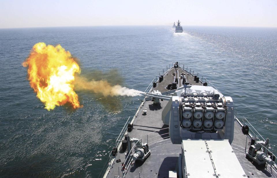 In this April 26, 2012 file photo released by China's Xinhua News Agency, Chinese navy's missile destroyer DDG-112 Harbin fires a shell during the China-Russia joint naval exercise in the Yellow Sea. Japan is concerned that China's increased naval operations in the western Pacific coupled with a lack of transparency over who sets the country's military agenda are posing a security threat in the region, according to its annual defense report released Tuesday, July 31. (AP Photo/Xinhua, Wu Dengfeng, File) NO SALES