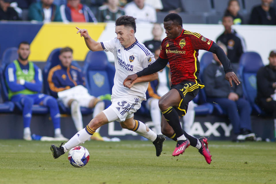 LA Galaxy forward Preston Judd, left, and Seattle Sounders defender Nouhou vie for the ball during the second half of an MLS soccer match in Carson, Calif., Saturday, April1, 2023. (AP Photo/Ringo H.W. Chiu)