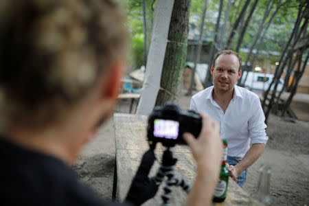 Activist Jonathan Whitlam (L) interviews British citizen Rob, who lives in Fridriechshain district in Berlin, Germany, July 19, 2017. REUTERS/Axel Schmidt