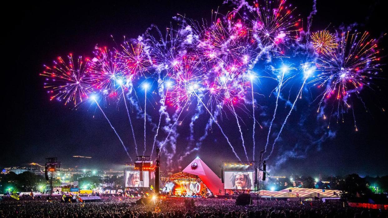 Long shot of the Pyramid Stage, lit up with Fireworks