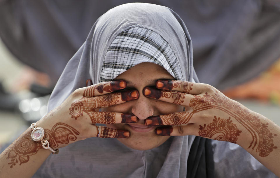 Indian Muslim students practice yoga ahead of International Yoga Day at a school in Ahmadabad, India, Tuesday, June 18, 2019. International Yoga Day will be celebrated on June 21. (AP Photo/Ajit Solanki)